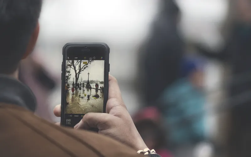 A person taking a photo on a smartphone